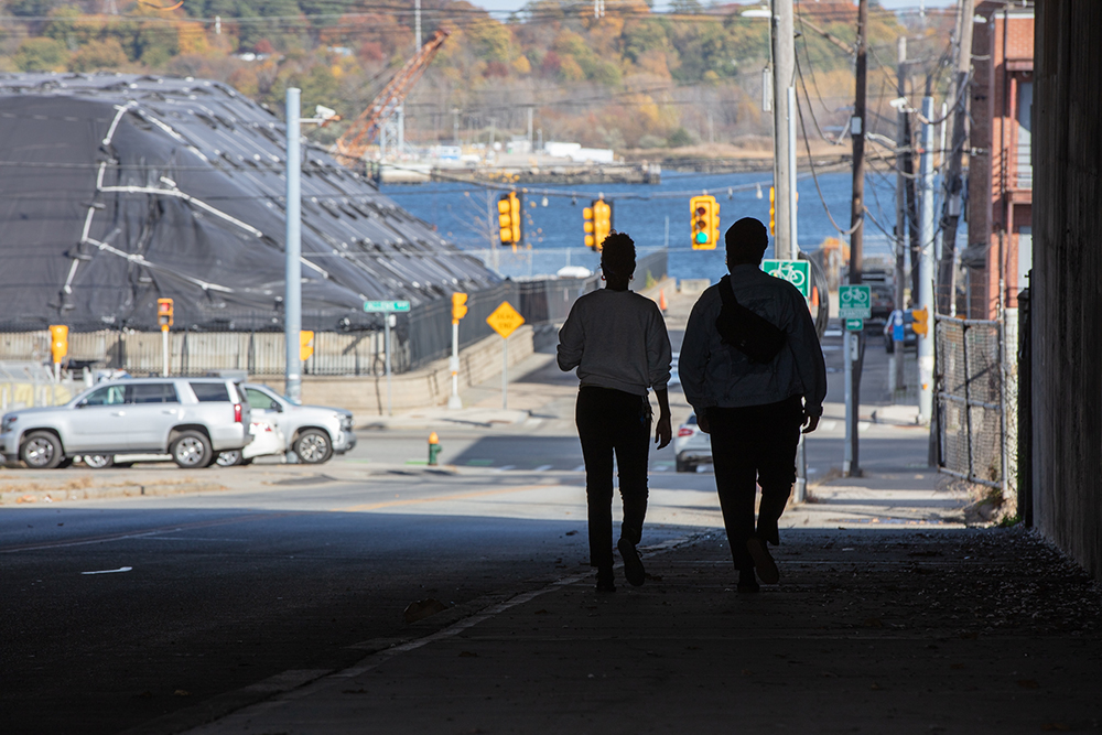 Artist collaborators walking on Public Street in Providence toward the port of Providence. Photo by Dominique Sindayiganza Photography