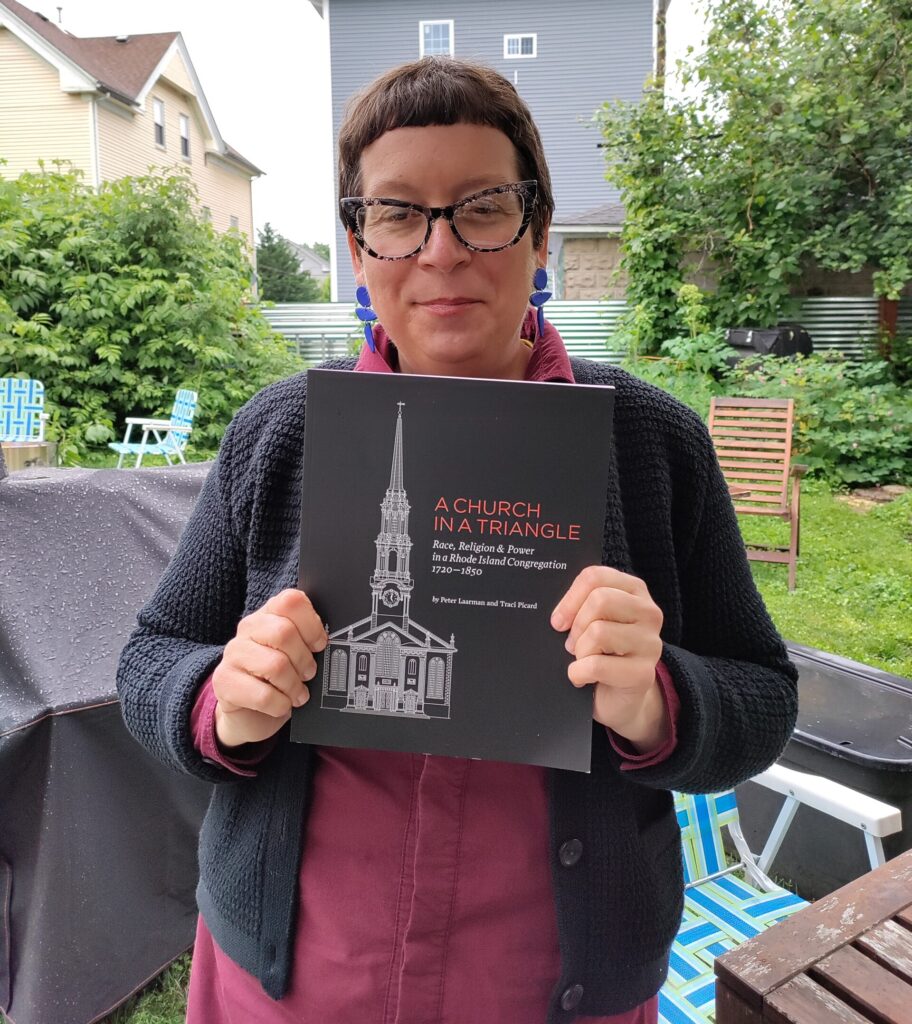 Writer Traci Picard holding her recent book, “A Church in a Triangle.”